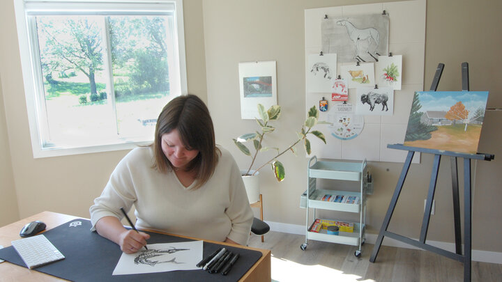 Abbey Snyder draws a pallid sturgeon