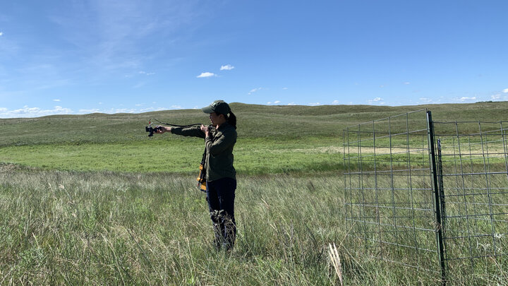 Catherine Chan uses a spectrometer on Barta Brothers Ranch to see how the vegetation reflects light.