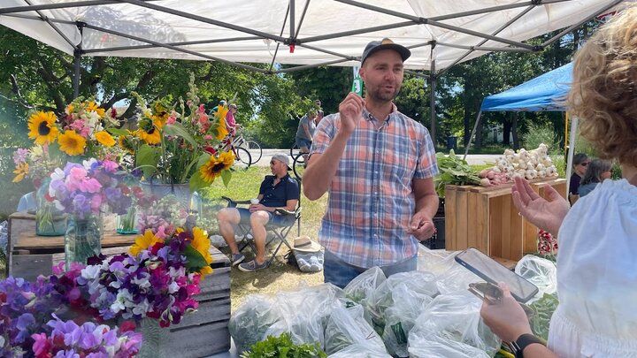 Russell Rolffs sells flowers at local farmers market in Wisconsin