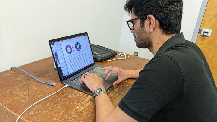 Photo of Sechindra Vallury working at computer