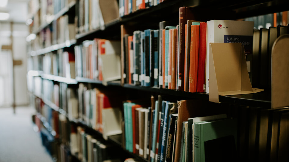 books on a shelf in a college library
