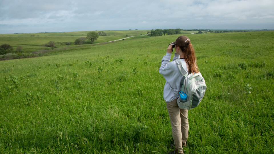 student looking out across the prairie