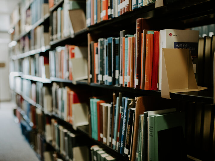 books on a shelf in a college library