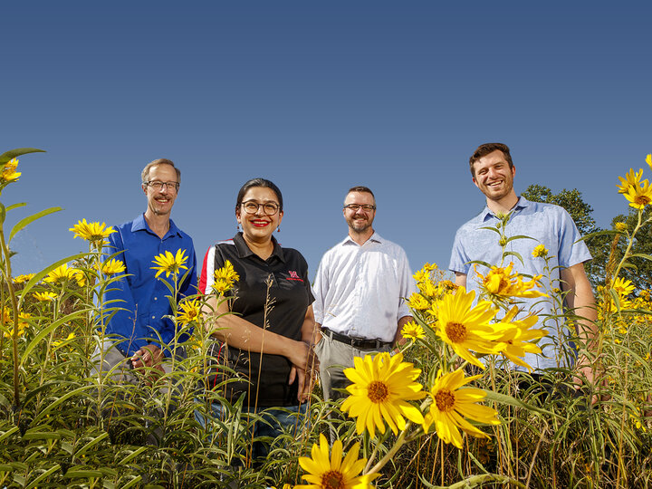 Photo of Craig Allen, Simanti Banerjee, Dirac Twidwell, and Dan Uden in a prairie