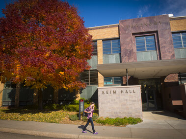 student walking in front of keim hall