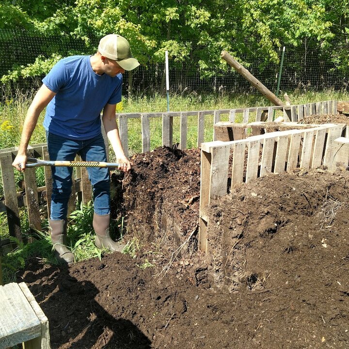Russell Rolffs turns compost at his 17 acre farm